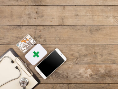 smartwatch could help track blood pressure drops/Parkinson's News Today/smartphone with first aid kid image