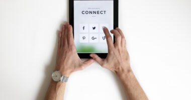 Technology allowing at-home care/Parkinson's News Today/person connecting on a portable device