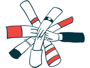 People joining their hands together in a show of support for one another.