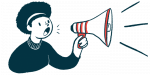 A person shouts into a megaphone to make an announcement.