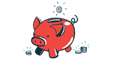 A coin is ready to drop into the slot of a pig-shaped piggy bank.