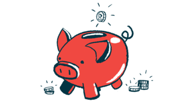 A coin is ready to drop into the slot of a pig-shaped piggy bank.