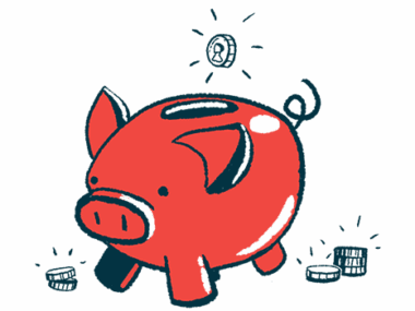 A coin is ready to drop into the slot of a pig-shaped piggy bank.