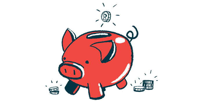 A coin is ready to drop into the slot of a pig-shaped piggy bank.