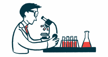 A researcher in a laboratory looks into a microscope.