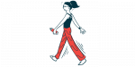 A person walks for exercise while carrying a water bottle in one hand.