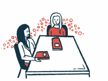 Two people are shown taking to one another while sitting at a table.