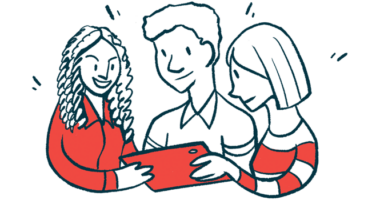 Three people cluster together to read information on a tablet.