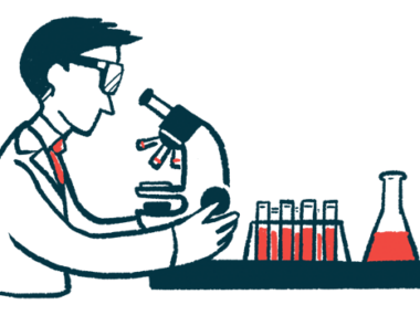 A clinical researcher uses a microscope to examine vials of fluid.