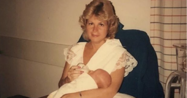 An old family photo of George's mother holding him as a baby.