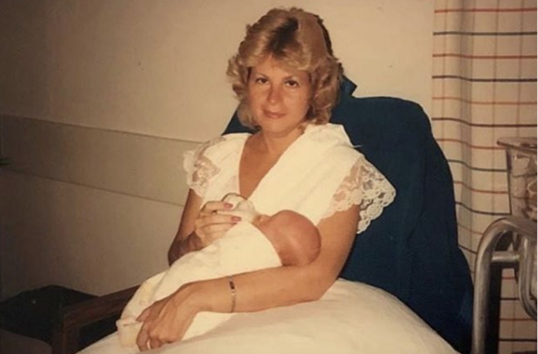 An old family photo of George's mother holding him as a baby.