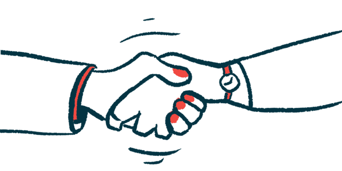 Two hands are seen clasped in a handshake.