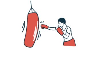 A person wearing boxing gloves hits a punching bag.