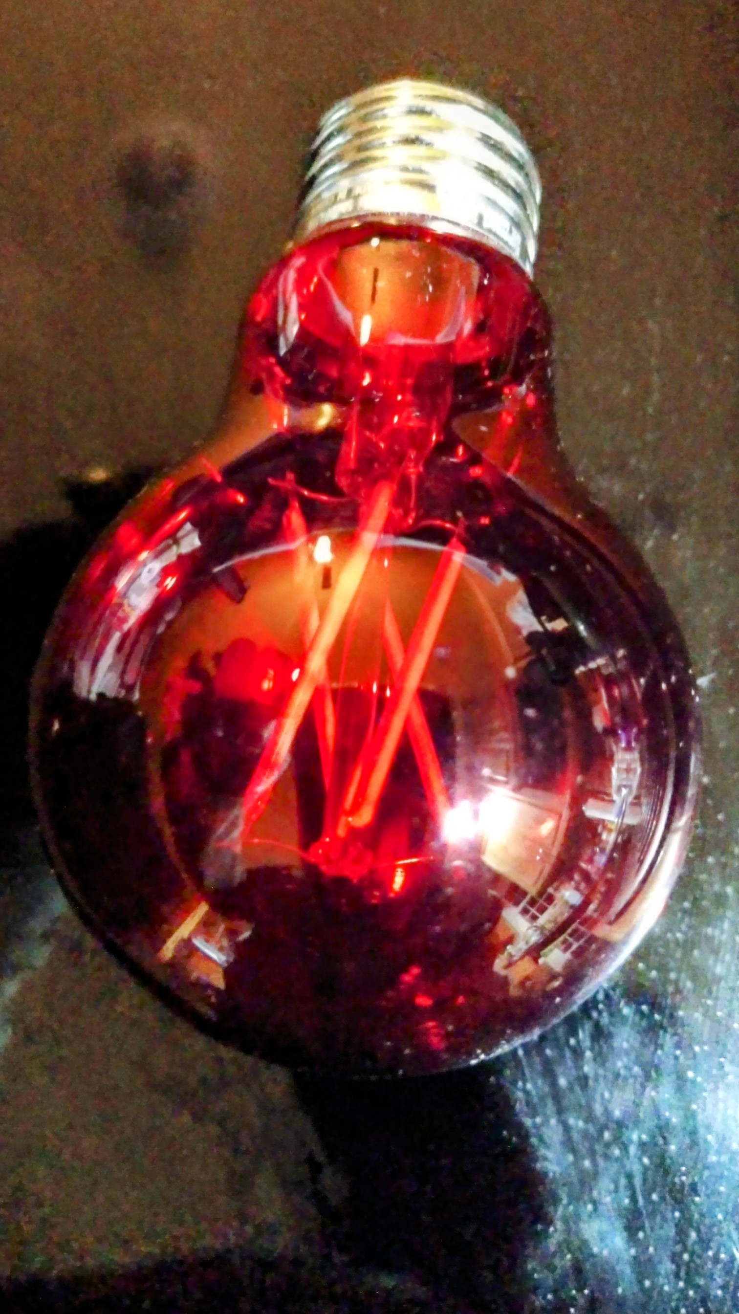 A close-up photo shows a red lightbulb.