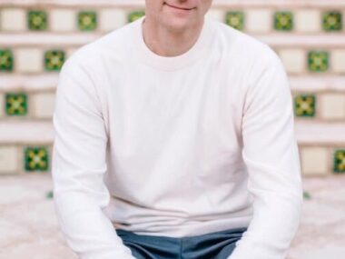 George Ackerman is shown seated on a bench in this photograph.