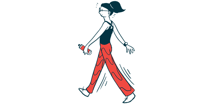 A person holding a water bottle in one hand is seen walking at a brisk pace.