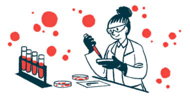 A scientist uses a dropper and a petri dish in a lab, alongside a rack with four filled vials.