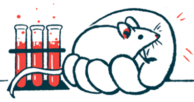 A mouse sits in the palm of an oversized human hand, pictured alongside a rack of filled test tubes.