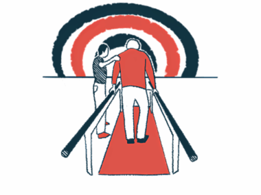 A therapist works with a patient walking between two handrails.