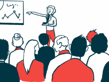 A speaker gives a presentation to a large audience at a conference, using a white board to show data.