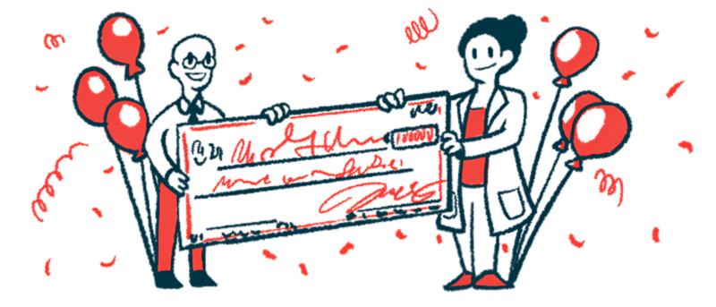 Two researchers each hold one end of a giant check.