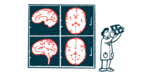 Images from a brain scan are projected on a wall next to a researcher who reviews a copy of them.