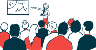 A person points to a chart while an audience listens.