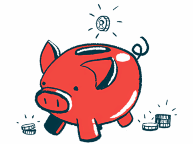 A coin is seen just above the slot on a pig-shaped bank.