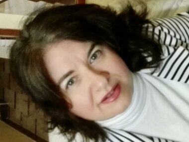 A close-up selfie-type profile photo that's rotated at an angle to add dynamic to it.