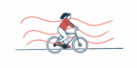 A woman in a red sweater rides a bicycle.