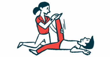 A physical therapist moves a patient's leg.