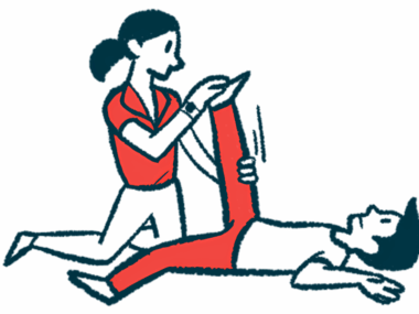 A physical therapist moves a patient's leg.