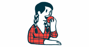 A person prepares to bite into an apple.