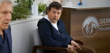 Michael J. Fox in an episode of "Shrinking" sitting in a doctor's office with Harrison Ford