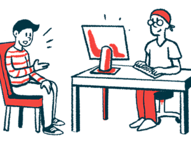 A seated person talks with another individual who is in a desk using a computer.