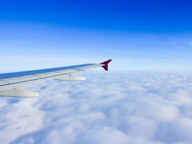 Wing of a plane flying in the sky.